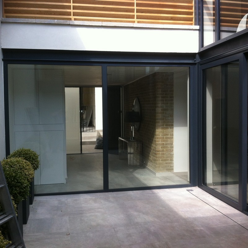 Floor-to-ceiling sliding doors opening to courtyard in Barnes