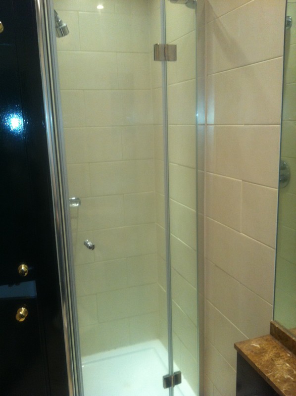 Frameless glass shower enclosure with chrome fittings in Barnes
