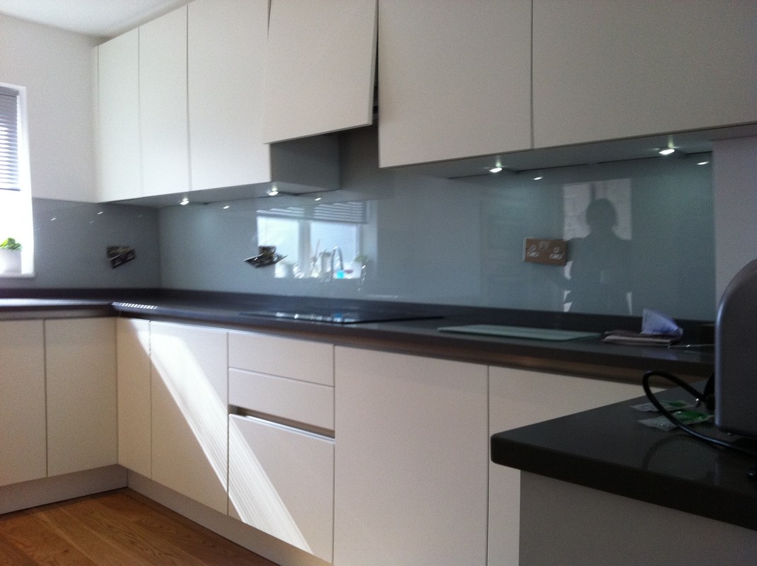 Grey glass kitchen splashback with LED lighting in Barnes
