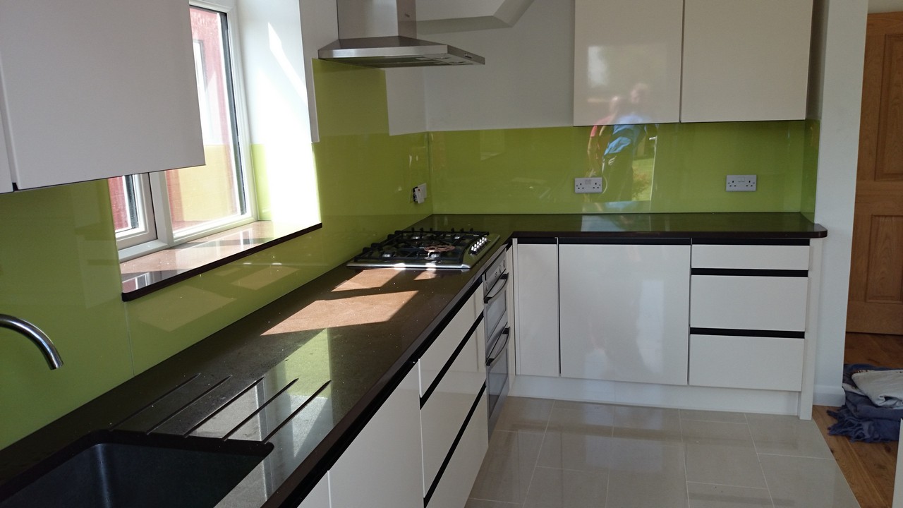 Lime green glass kitchen splashback installed by Barnes glaziers